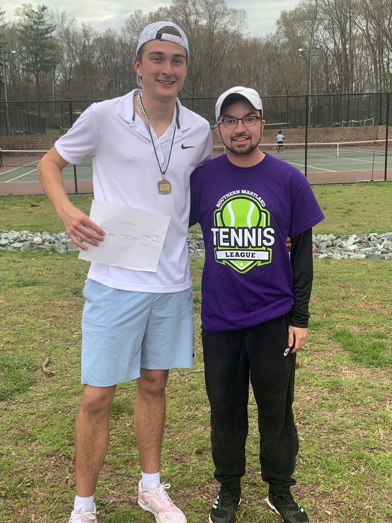Junior tennis players on court