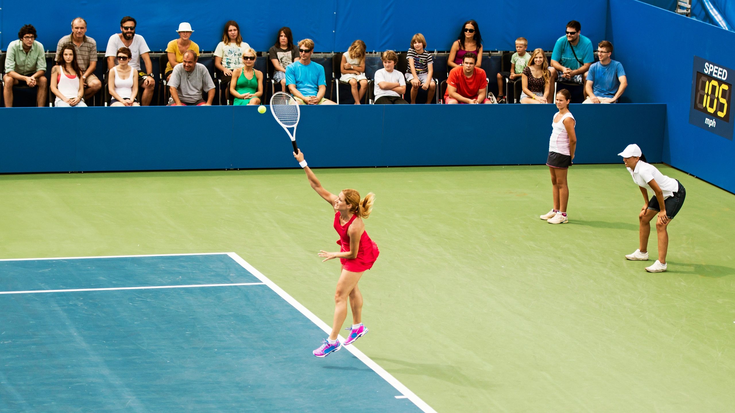 Tennis player serving on court